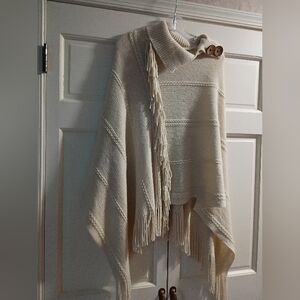 NWT.Cream Knit Poncho with Fringe and Button Detail